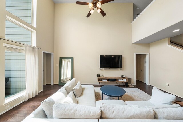 1406 Kallie Hills Ln, Spring, TX 77386 - living room featuring a towering ceiling, a ceiling fan, wood finished floors, and baseboards