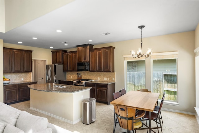 1406 Kallie Hills Ln, Spring, TX 77386 - kitchen featuring stainless steel appliances, a sink, a chandelier, dark brown cabinets, and recessed lighting