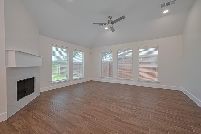 4046 Dell Ln, Missouri City, TX 77459 - unfurnished living room featuring vaulted ceiling, a high end fireplace, ceiling fan, wood finished floors, and recessed lighting