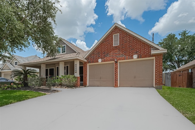 4046 Dell Ln, Missouri City, TX 77459 - view of front of property with brick siding, concrete driveway, covered porch, a shingled roof, and an attached garage