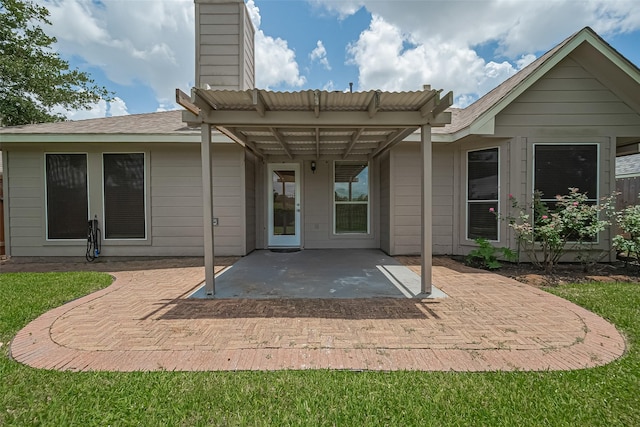 4046 Dell Ln, Missouri City, TX 77459 - rear view of house with a patio and a chimney