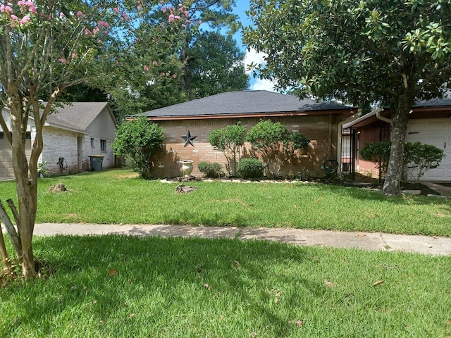 23407 Little Wind Ln, Spring, TX 77373 - view of property exterior featuring a lawn and brick siding