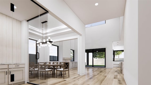 207 W 33rd St, Houston, TX 77018 - entrance foyer featuring a high ceiling, healthy amount of natural light, wood finished floors, and a chandelier
