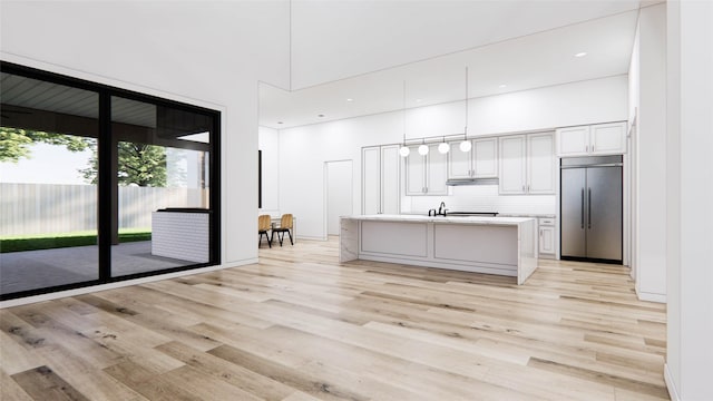 207 W 33rd St, Houston, TX 77018 - kitchen with stainless steel built in fridge, light wood-type flooring, backsplash, light countertops, and hanging light fixtures