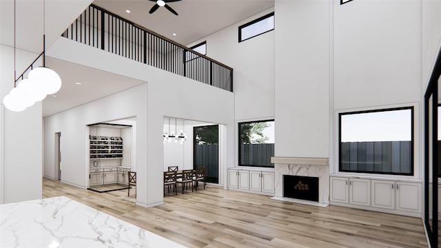 207 W 33rd St, Houston, TX 77018 - living area featuring a high ceiling, wood finished floors, ceiling fan, a chandelier, and a fireplace