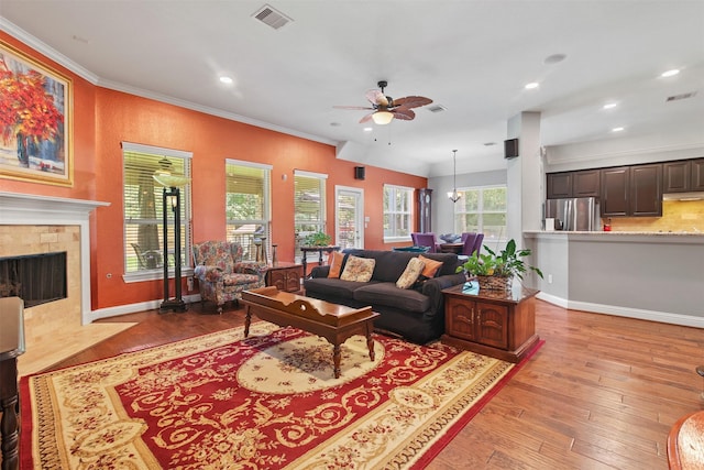 18 Brookefield Cir, Magnolia, TX 77355 - living area with a ceiling fan, ornamental molding, hardwood / wood-style flooring, recessed lighting, and a tile fireplace