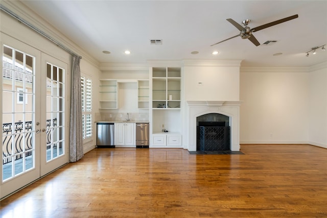 5507 Val Verde St, Houston, TX 77056 - unfurnished living room featuring ornamental molding, ceiling fan, wood finished floors, bar area, and french doors