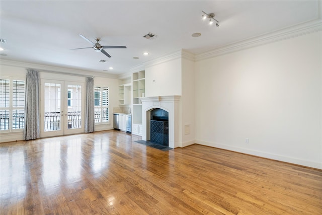 5507 Val Verde St, Houston, TX 77056 - unfurnished living room with ceiling fan, ornamental molding, a fireplace with flush hearth, built in features, and light wood-style floors