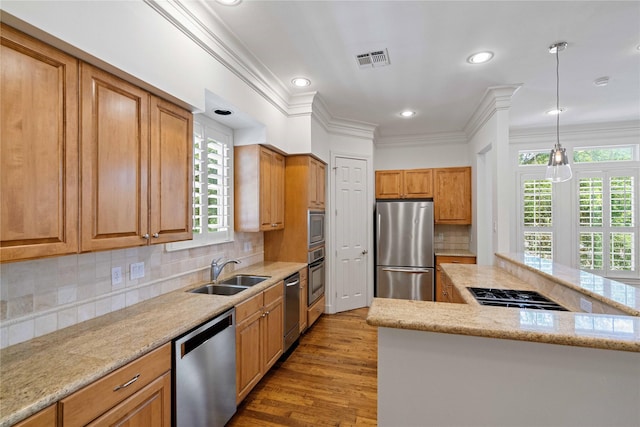 5507 Val Verde St, Houston, TX 77056 - kitchen featuring stainless steel appliances, crown molding, wood finished floors, pendant lighting, and recessed lighting