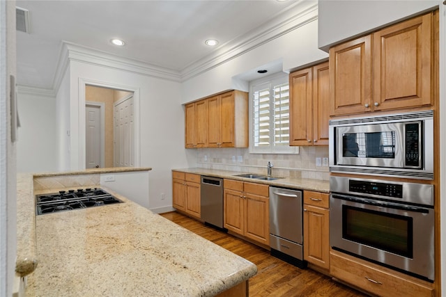 5507 Val Verde St, Houston, TX 77056 - kitchen featuring stainless steel appliances, crown molding, tasteful backsplash, wood finished floors, and recessed lighting