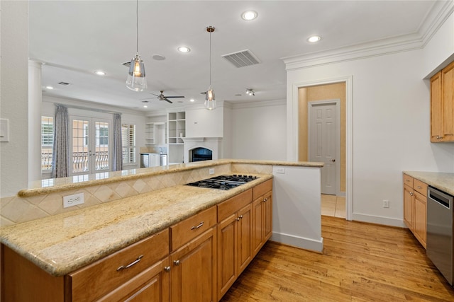 5507 Val Verde St, Houston, TX 77056 - kitchen with appliances with stainless steel finishes, light wood-type flooring, a ceiling fan, crown molding, and a fireplace