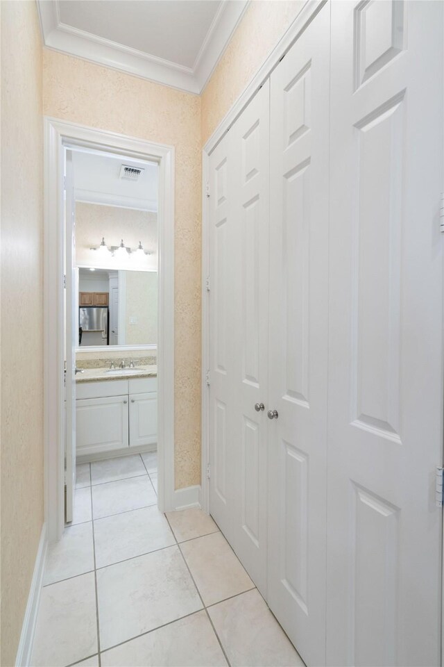 5507 Val Verde St, Houston, TX 77056 - hallway featuring ornamental molding and light tile patterned flooring
