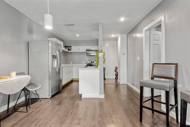 3300 Yorktown St Unit 24, Houston, TX 77056 - kitchen with stainless steel appliances, white cabinetry, dark wood-type flooring, light countertops, and recessed lighting