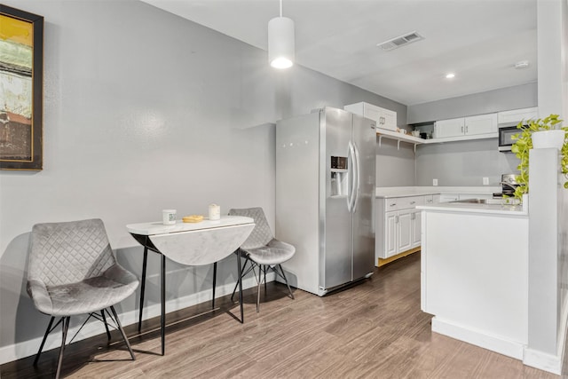 3300 Yorktown St Unit 24, Houston, TX 77056 - kitchen with appliances with stainless steel finishes, light wood-style floors, white cabinets, light countertops, and recessed lighting