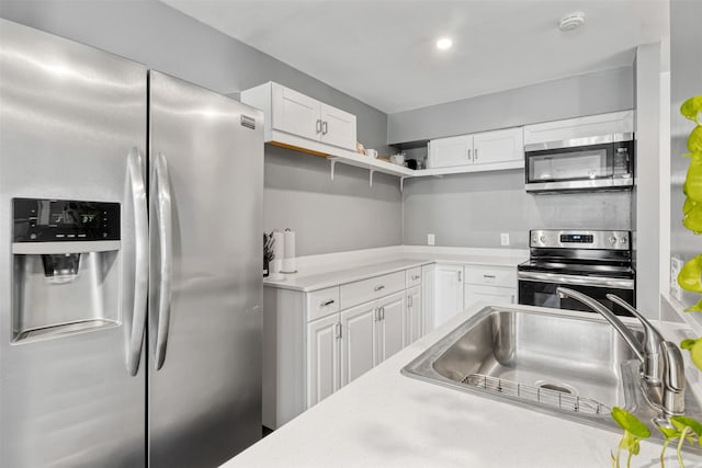 3300 Yorktown St Unit 24, Houston, TX 77056 - kitchen featuring stainless steel appliances, a sink, light countertops, white cabinetry, and open shelves