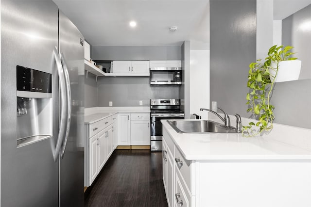 3300 Yorktown St Unit 24, Houston, TX 77056 - kitchen featuring stainless steel appliances, a sink, dark wood-type flooring, open shelves, and white cabinetry