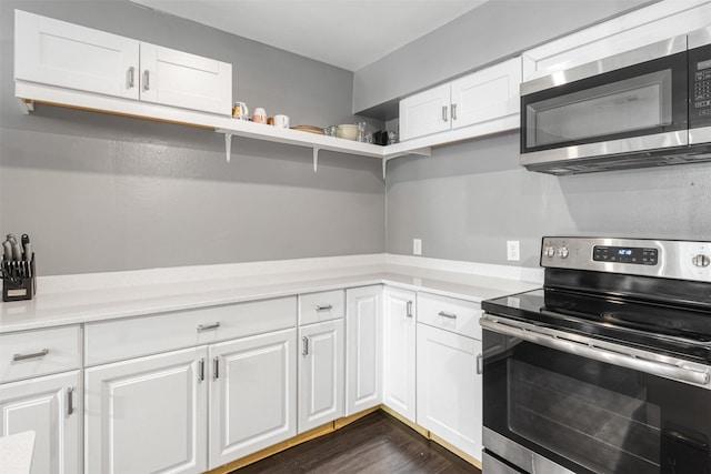 3300 Yorktown St Unit 24, Houston, TX 77056 - kitchen featuring appliances with stainless steel finishes, light countertops, and white cabinetry