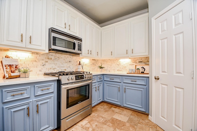 902 Cohn St, Houston, TX 77007 - kitchen featuring appliances with stainless steel finishes, decorative backsplash, and white cabinets