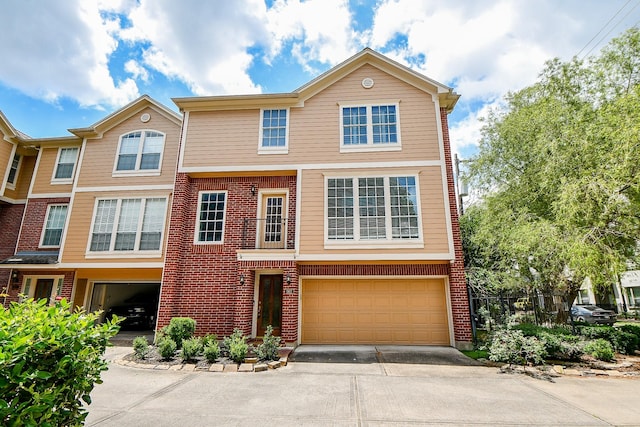 902 Cohn St, Houston, TX 77007 - view of property with concrete driveway, a garage, and brick siding