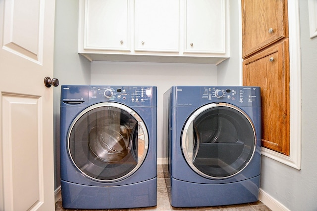 902 Cohn St, Houston, TX 77007 - laundry room featuring cabinet space, washer and dryer, and baseboards