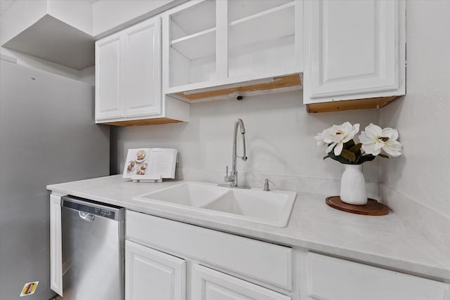 11731 Bexar Dr, La Porte, TX 77571 - kitchen featuring dishwasher, a sink, white cabinets, and light countertops