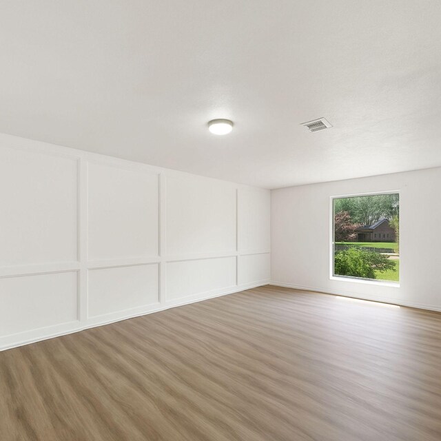 11731 Bexar Dr, La Porte, TX 77571 - empty room featuring light wood-style floors and a decorative wall