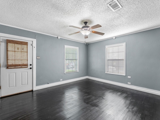 809 18th Ave N, Texas City, TX 77590 - spare room featuring a ceiling fan, a textured ceiling, dark wood-style flooring, baseboards, and crown molding