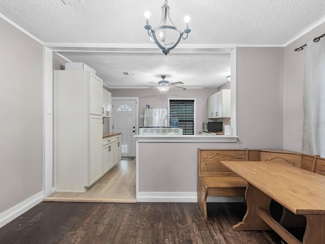 809 18th Ave N, Texas City, TX 77590 - kitchen with fridge, a textured ceiling, white cabinetry, light wood-style floors, and ceiling fan
