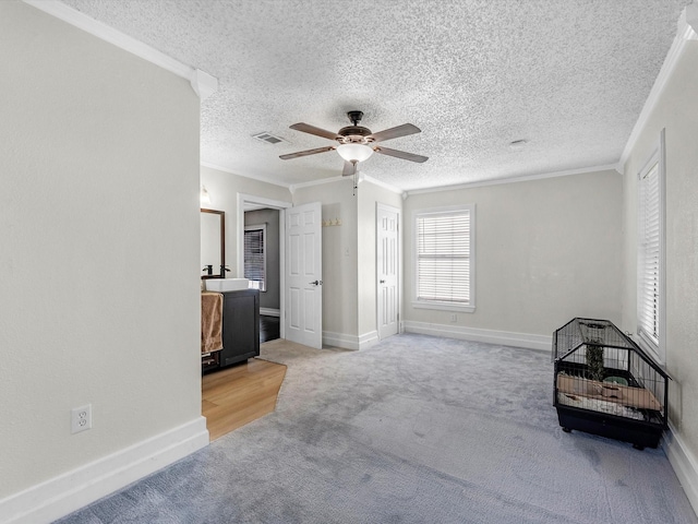 809 18th Ave N, Texas City, TX 77590 - unfurnished bedroom with ornamental molding, carpet floors, a textured ceiling, ceiling fan, and baseboards