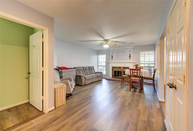 3402 Deeds Rd, Houston, TX 77084 - living area with a ceiling fan, plenty of natural light, wood finished floors, baseboards, and a textured ceiling