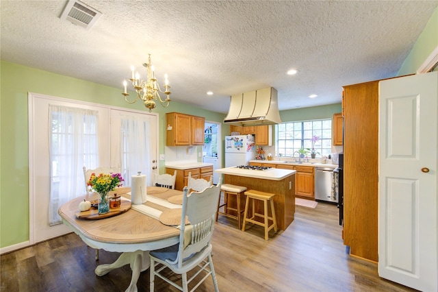 3402 Deeds Rd, Houston, TX 77084 - dining room with a chandelier, light wood-style flooring, a textured ceiling, and recessed lighting