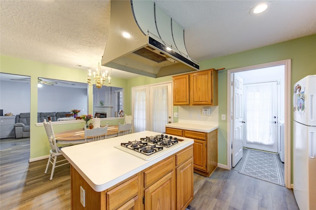 3402 Deeds Rd, Houston, TX 77084 - kitchen featuring white appliances, light countertops, dark wood-style flooring, extractor fan, and a chandelier