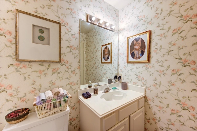 3402 Deeds Rd, Houston, TX 77084 - half bath featuring wallpapered walls, toilet, and vanity