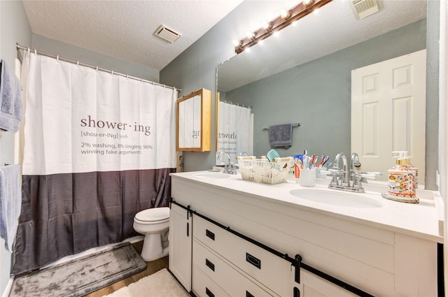 3402 Deeds Rd, Houston, TX 77084 - full bathroom with double vanity, toilet, a textured ceiling, curtained shower, and wood finished floors