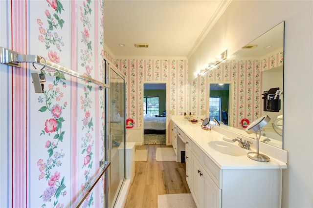 3402 Deeds Rd, Houston, TX 77084 - bathroom with ornamental molding, wood finished floors, vanity, wallpapered walls, and ensuite bathroom