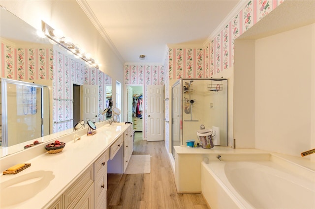 3402 Deeds Rd, Houston, TX 77084 - bathroom with wallpapered walls, crown molding, a shower stall, wood finished floors, and double vanity