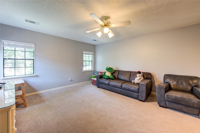 3402 Deeds Rd, Houston, TX 77084 - living area with carpet floors, baseboards, ceiling fan, and a textured ceiling