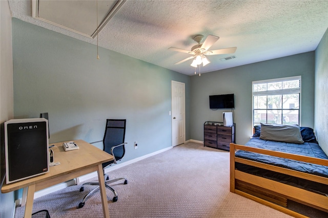 3402 Deeds Rd, Houston, TX 77084 - carpeted bedroom with attic access, a desk, a textured ceiling, baseboards, and a ceiling fan