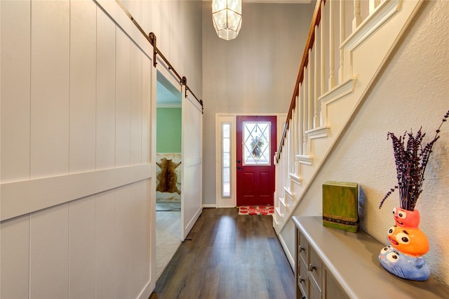 3402 Deeds Rd, Houston, TX 77084 - entryway featuring dark wood-type flooring, a chandelier, stairs, a barn door, and a towering ceiling