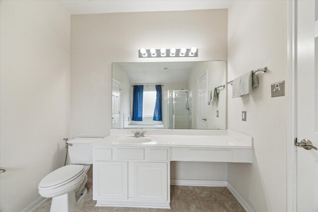 21551 Elm Hurst Ln, Katy, TX 77450 - bathroom featuring a shower stall, toilet, vanity, tile patterned flooring, and baseboards