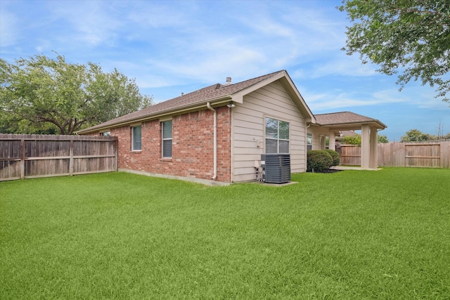 21551 Elm Hurst Ln, Katy, TX 77450 - back of house with central air condition unit, brick siding, and roof with shingles