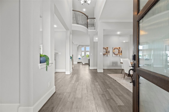 19307 Spillway Overlook Cir, Cypress, TX 77433 - foyer featuring wood finished floors, a high ceiling, crown molding, and recessed lighting