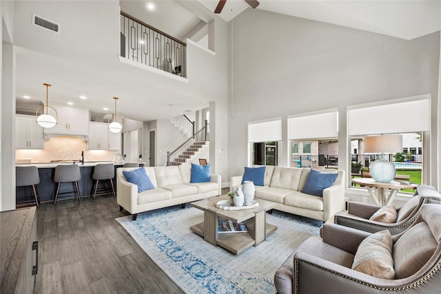 19307 Spillway Overlook Cir, Cypress, TX 77433 - living area with high vaulted ceiling, ceiling fan, dark wood-style floors, stairs, and recessed lighting