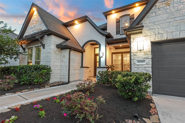 19307 Spillway Overlook Cir, Cypress, TX 77433 - view of front of property with stone siding, an attached garage, and stucco siding
