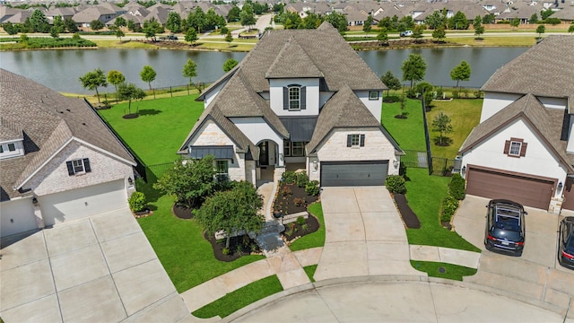 19307 Spillway Overlook Cir, Cypress, TX 77433 - view of front of home featuring a shingled roof, a garage, a residential view, a standing seam roof, and stone siding
