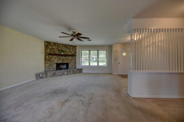 906 Carlee Dr, Brenham, TX 77833 - unfurnished living room with ceiling fan, carpet, baseboards, and a fireplace