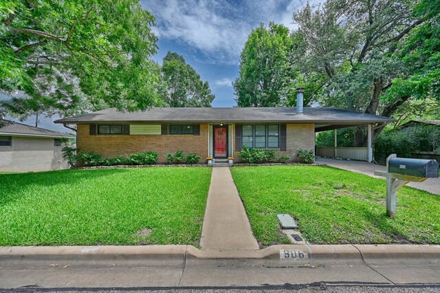 906 Carlee Dr, Brenham, TX 77833 - view of front of property with brick siding, an attached carport, and a front lawn