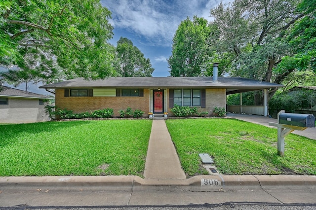 906 Carlee Dr, Brenham, TX 77833 - view of front facade with brick siding, an attached carport, and a front yard