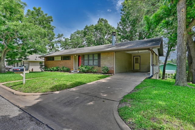 906 Carlee Dr, Brenham, TX 77833 - ranch-style house featuring brick siding, driveway, a front lawn, and an attached carport