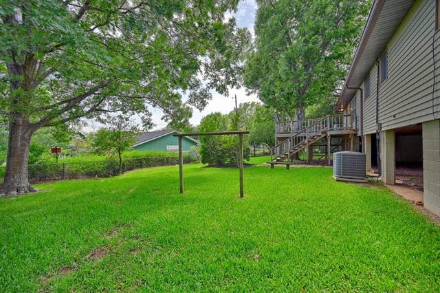 906 Carlee Dr, Brenham, TX 77833 - view of yard with central AC, stairs, and a deck